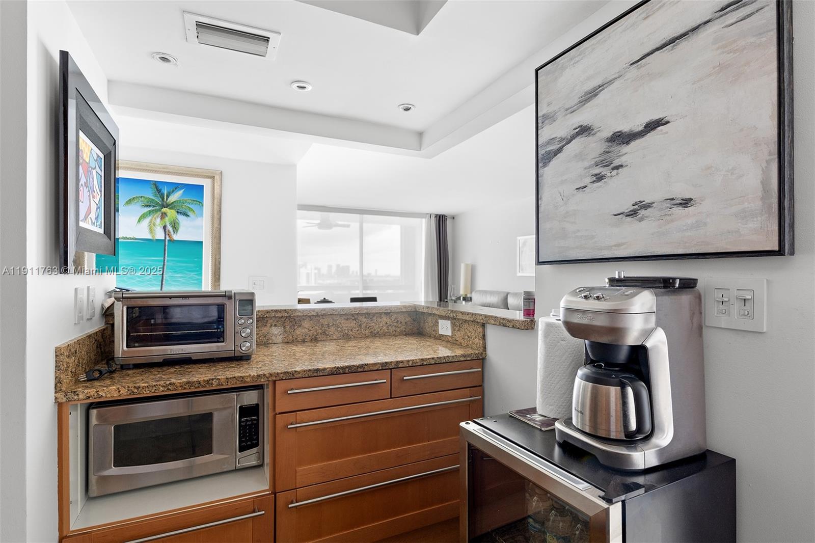1775 Washington Avenue, Unit 14F Miami Beach, FL 33139 - Photo 10 of 25 a kitchen with a stove and a microwave