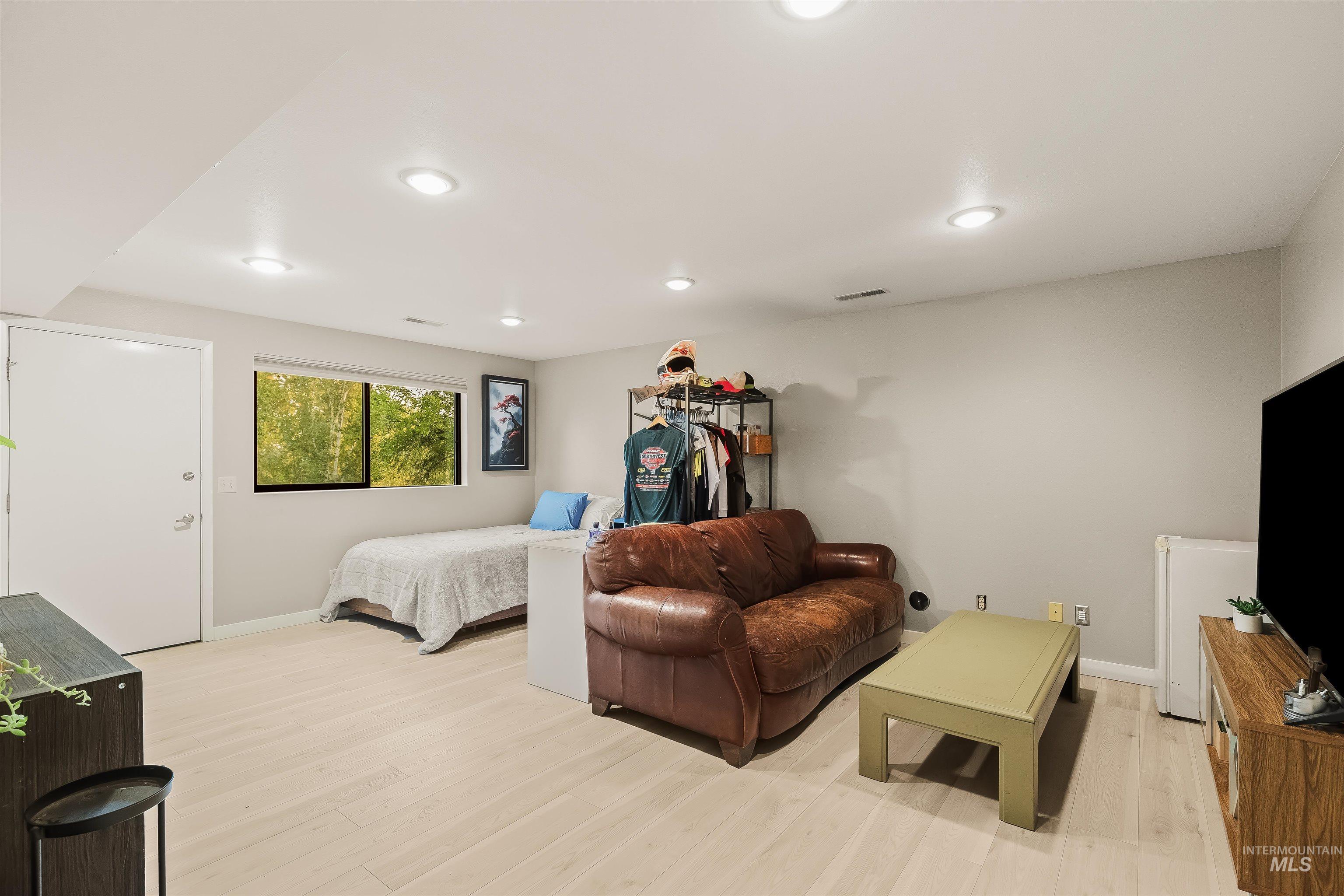 2048 Arborcrest Road Moscow, ID 83843 - Photo 32 of 50 Recessed lighting, wood-finish flooring, white trim, and a window with natural scenery