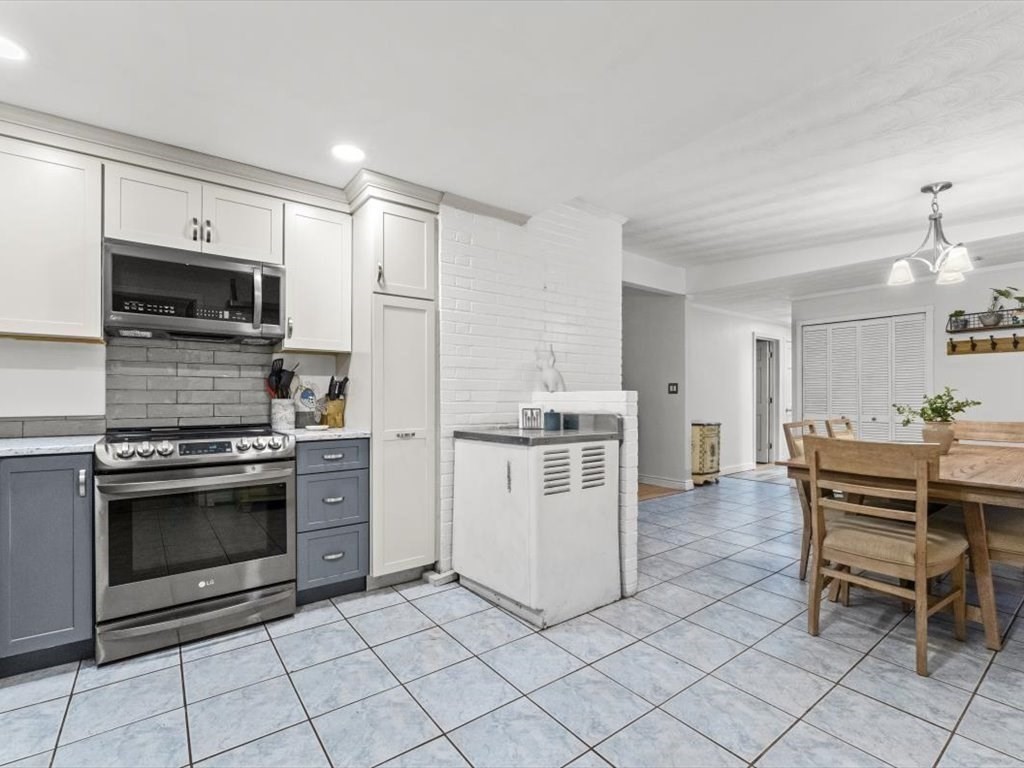 15 Rosslare Road Framingham, MA 01701 - Photo 11 of 37 a kitchen with white cabinets and stainless steel appliances