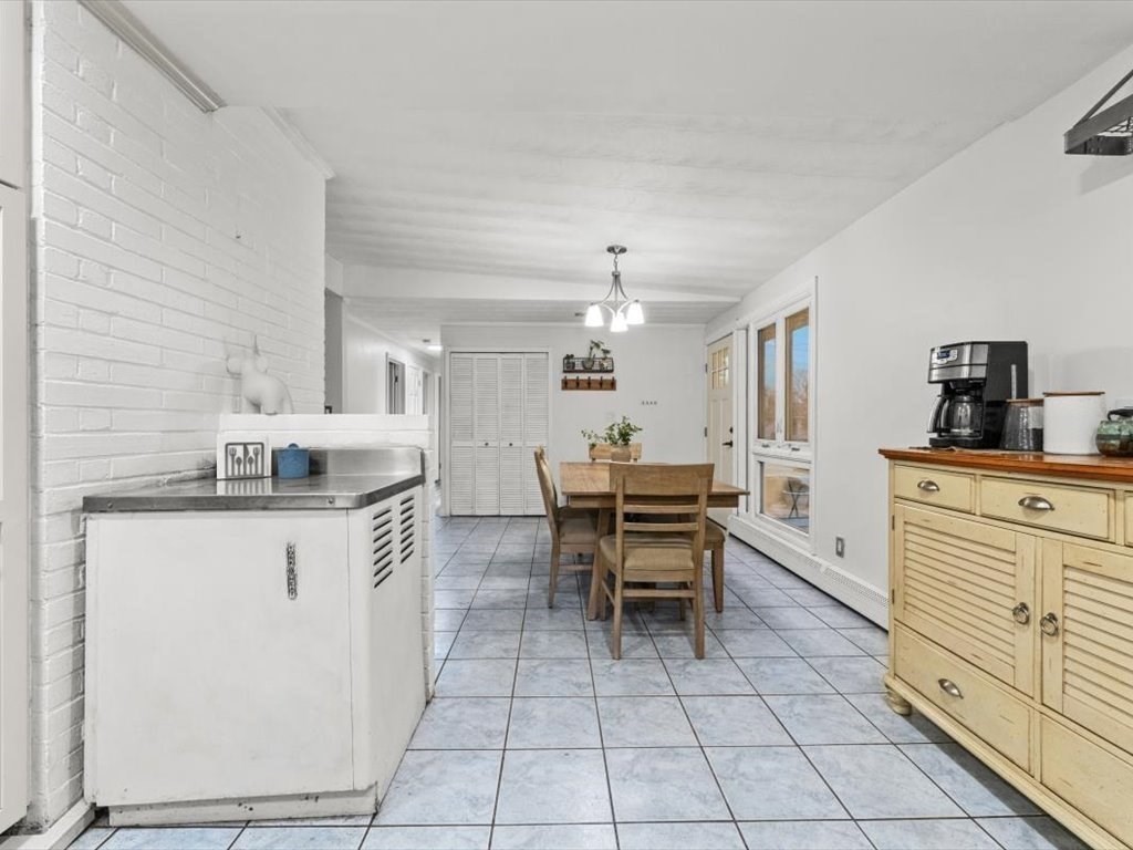 15 Rosslare Road Framingham, MA 01701 - Photo 12 of 37 a kitchen with white cabinets and appliances