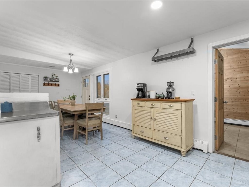 15 Rosslare Road Framingham, MA 01701 - Photo 13 of 37 a kitchen with a table chairs and microwave