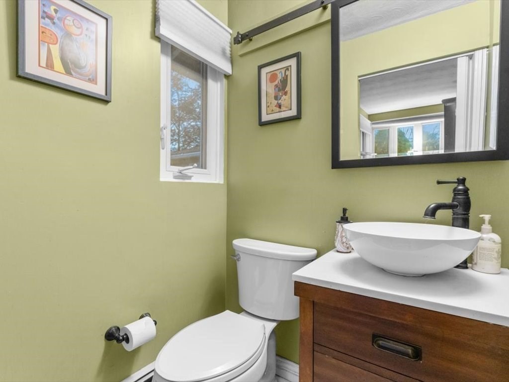 15 Rosslare Road Framingham, MA 01701 - Photo 25 of 37 a bathroom with a toilet a sink and mirror