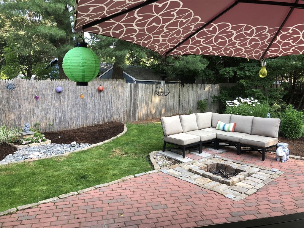 15 Rosslare Road Framingham, MA 01701 - Photo 35 of 37 a view of a backyard with couches potted plants and wooden fence