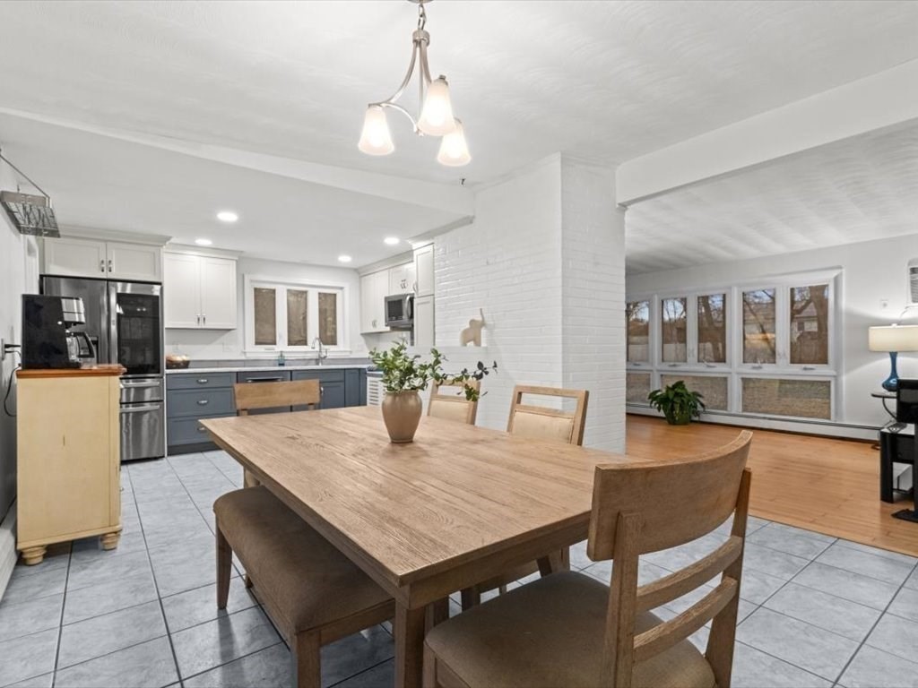 15 Rosslare Road Framingham, MA 01701 - Photo 7 of 37 a view of a dining room and livingroom with furniture wooden floor a chandelier