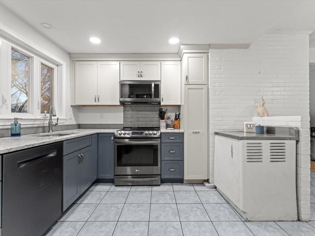 15 Rosslare Road Framingham, MA 01701 - Photo 10 of 37 a kitchen with stainless steel appliances a stove sink and microwave