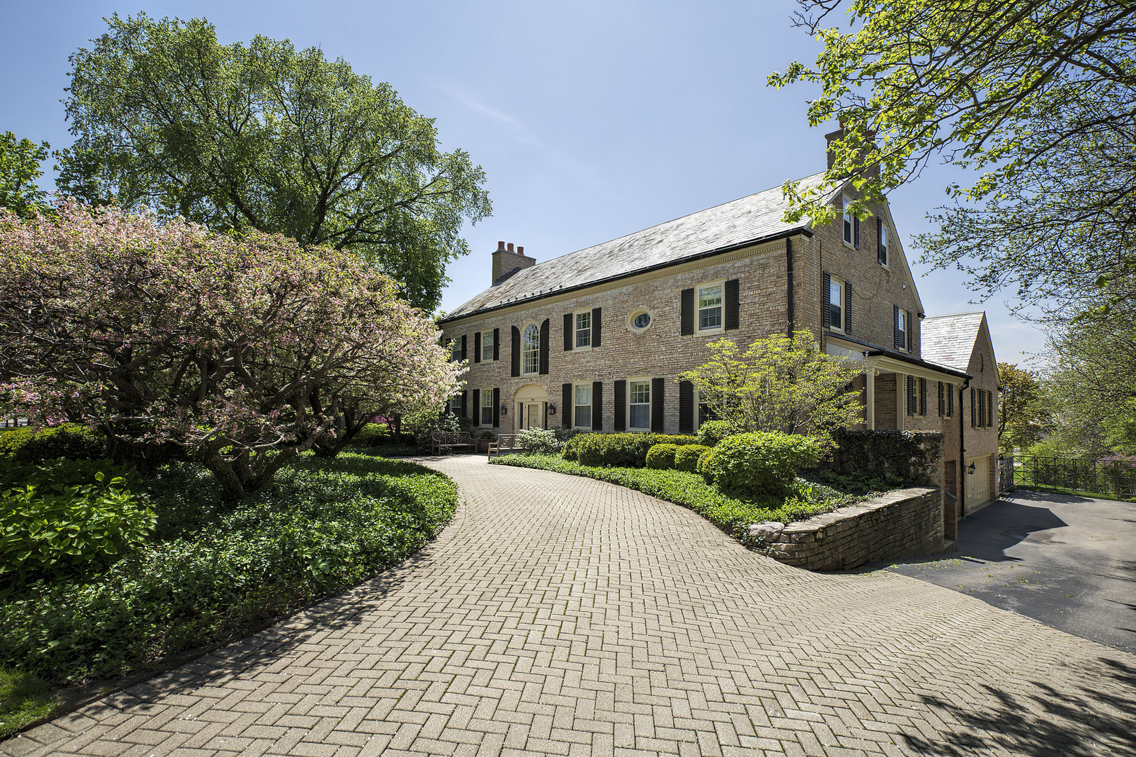 780 Bluff Street Glencoe, IL 60022 - Photo 1 of 1 a front view of a house with a yard and potted plants