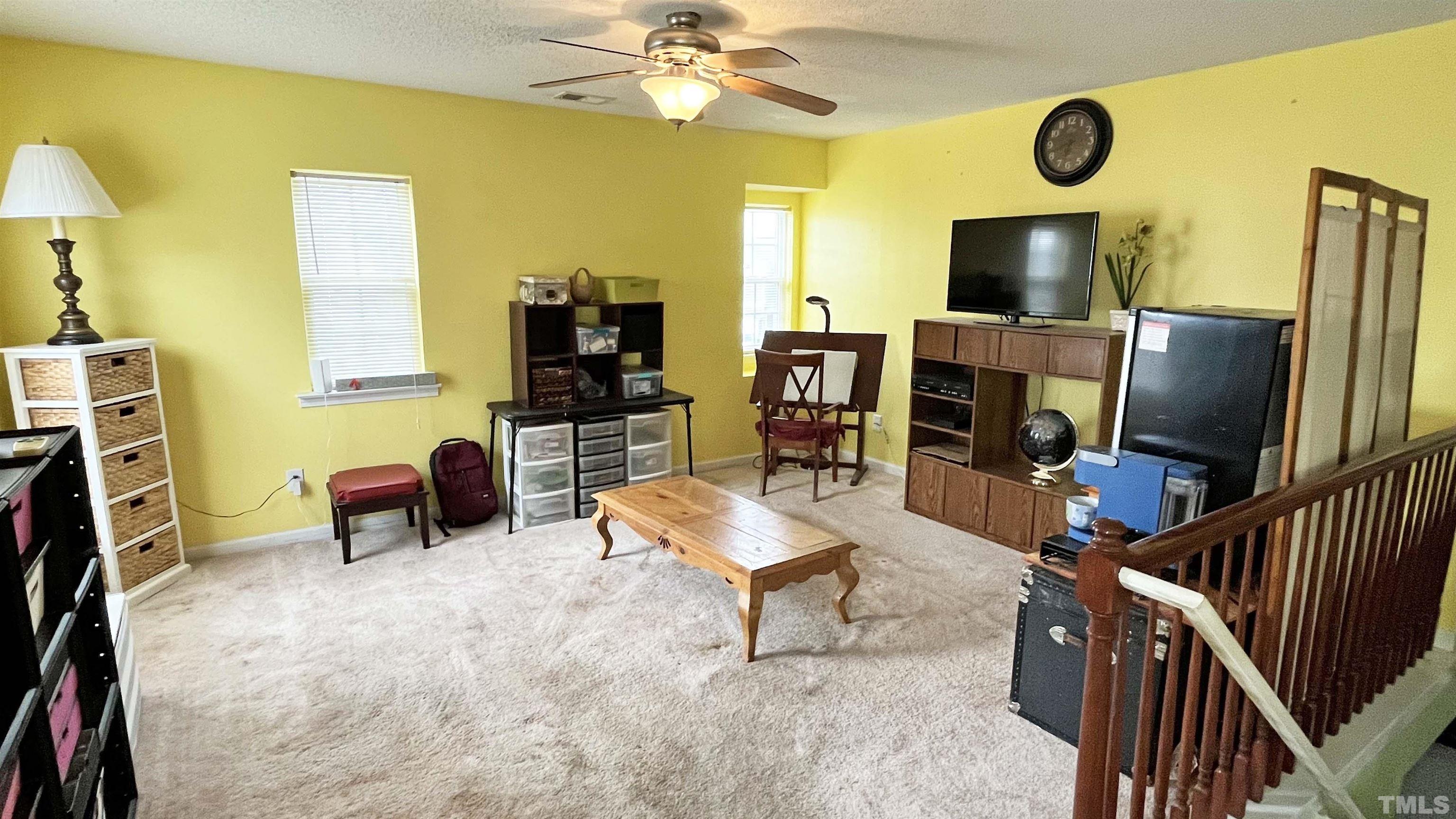 6122 Ricker Road Raleigh, NC 27610 - Photo 11 of 20 a room with furniture and a flat screen tv