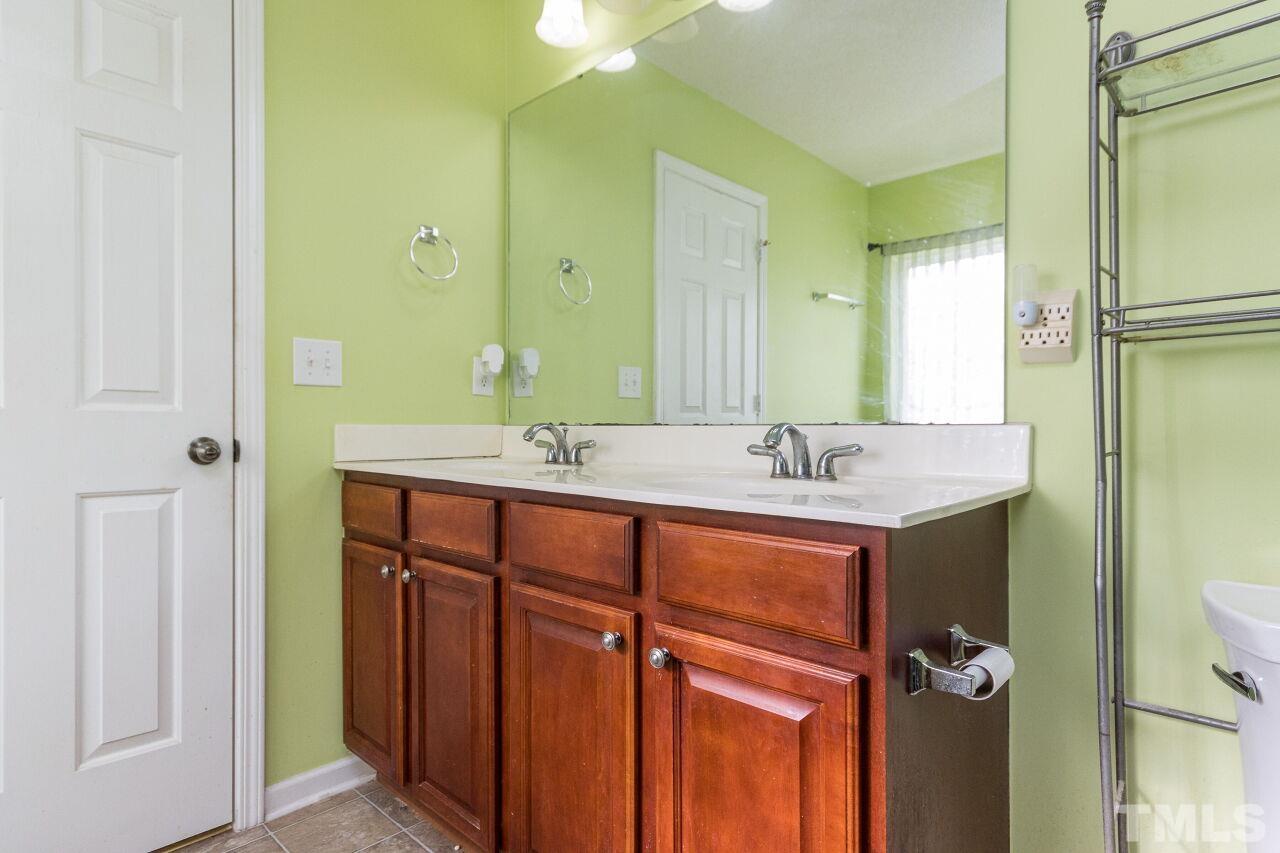 6122 Ricker Road Raleigh, NC 27610 - Photo 14 of 20 a bathroom with a sink and a mirror