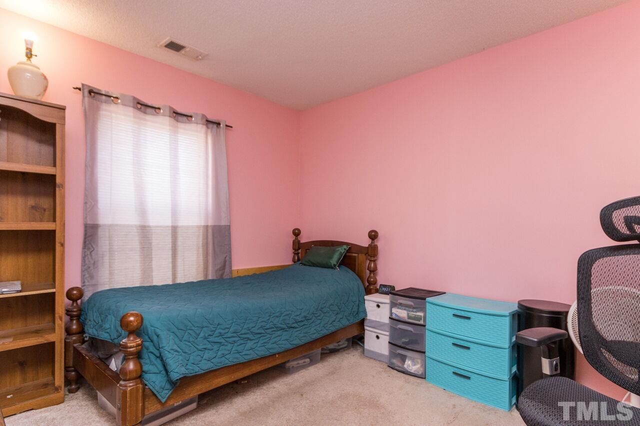 6122 Ricker Road Raleigh, NC 27610 - Photo 17 of 20 a bedroom with a bed and a window