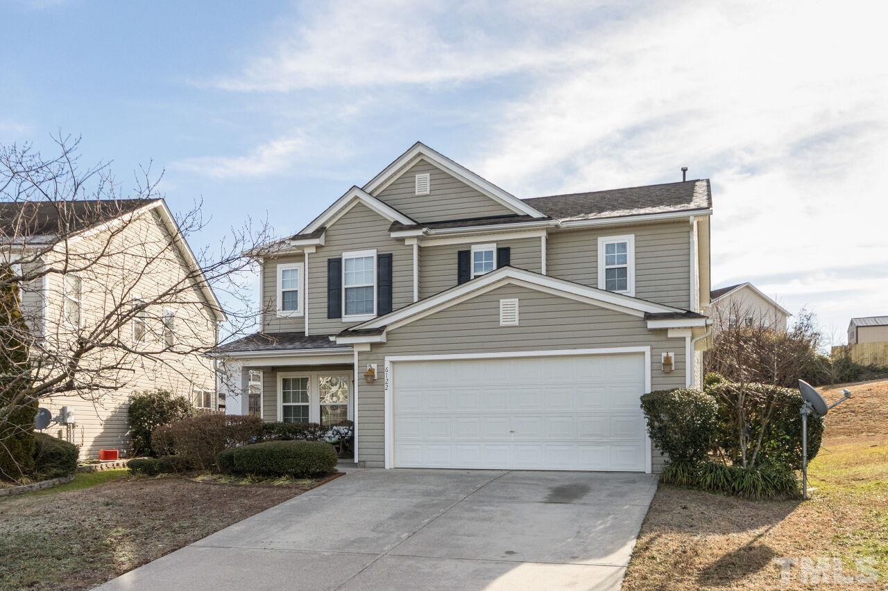 6122 Ricker Road Raleigh, NC 27610 - Photo 2 of 20 a front view of a house with a yard and garage