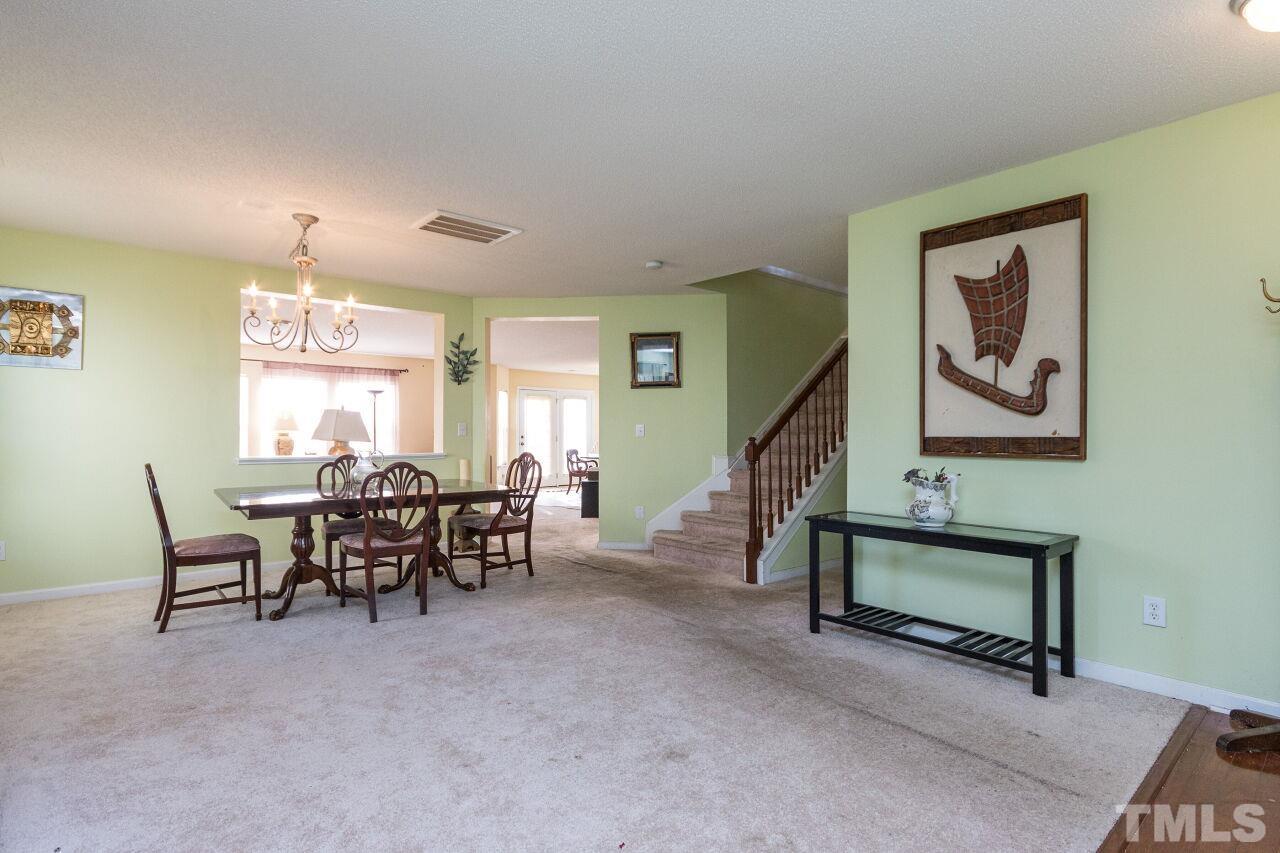 6122 Ricker Road Raleigh, NC 27610 - Photo 4 of 20 a dining room with furniture and window