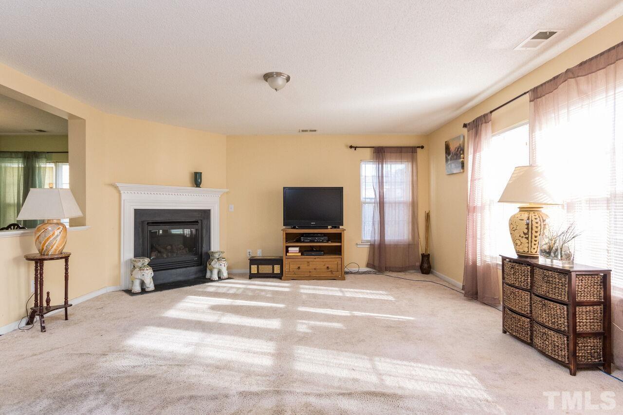 6122 Ricker Road Raleigh, NC 27610 - Photo 6 of 20 a view of a livingroom with furniture and a flat screen tv