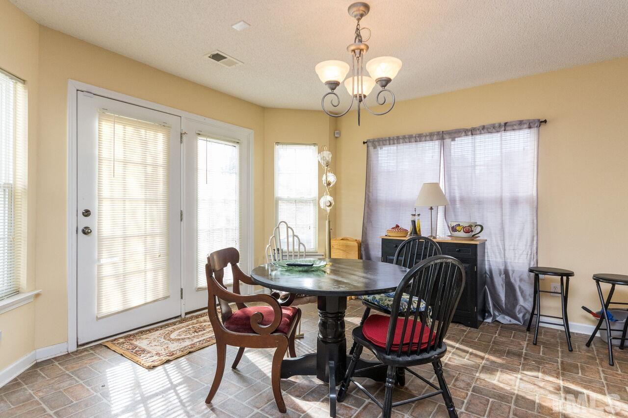 6122 Ricker Road Raleigh, NC 27610 - Photo 8 of 20 a view of a dining room with furniture window and outside view