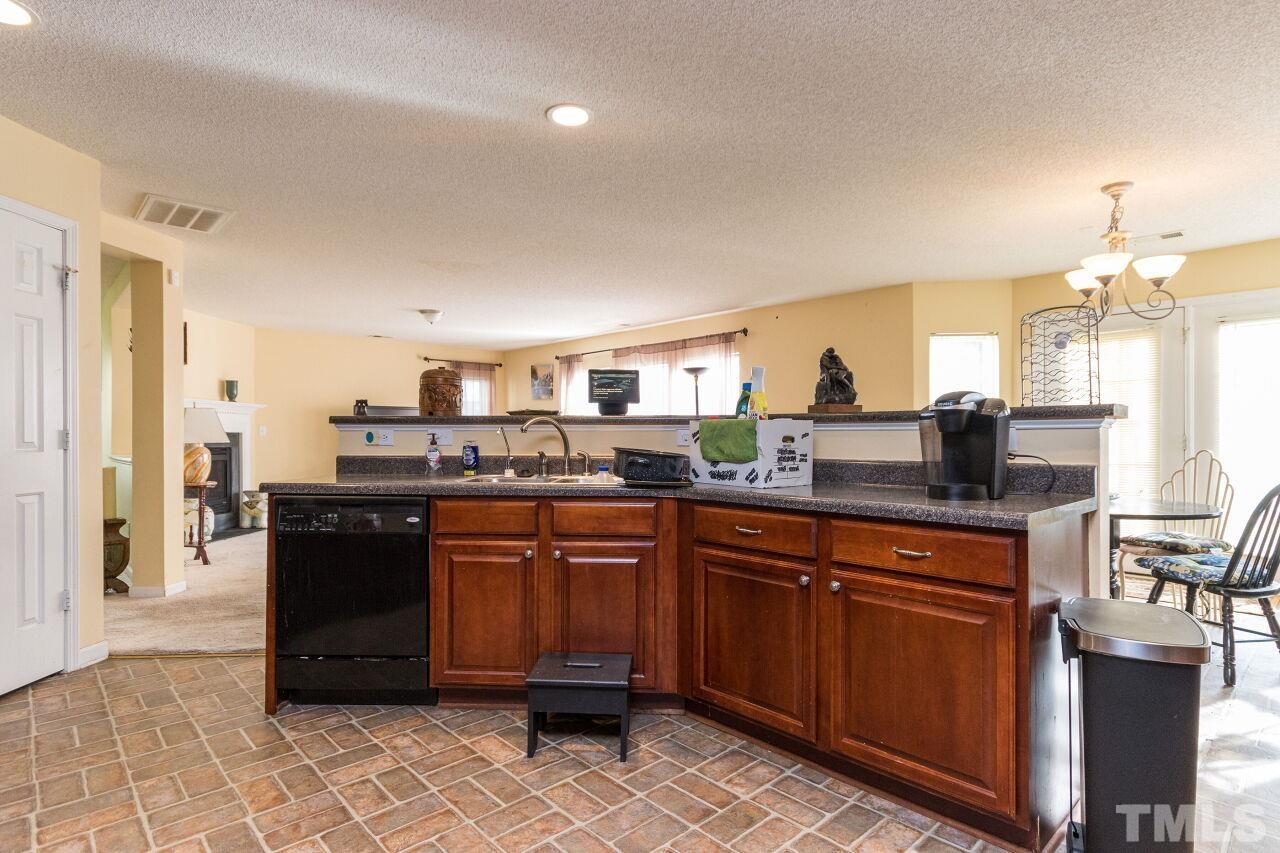 6122 Ricker Road Raleigh, NC 27610 - Photo 10 of 20 a kitchen with a sink and cabinets
