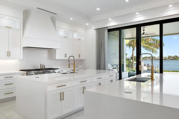 a large white kitchen with a large window
