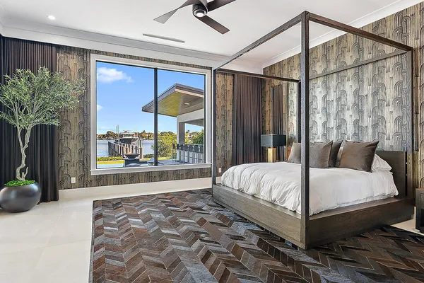 a bedroom with a large bed and a large window