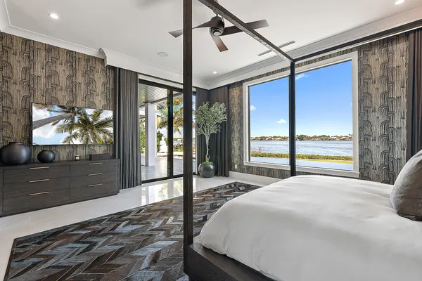 a bedroom with a large bed and a large window