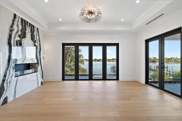 a view of an empty room with window and cabinet