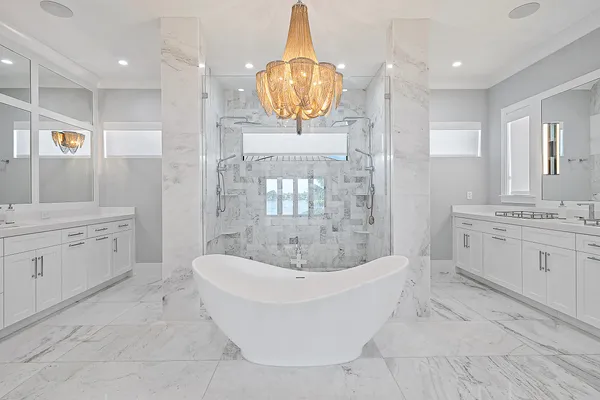 a bathroom with a double vanity sink a mirror a bathtub and shower