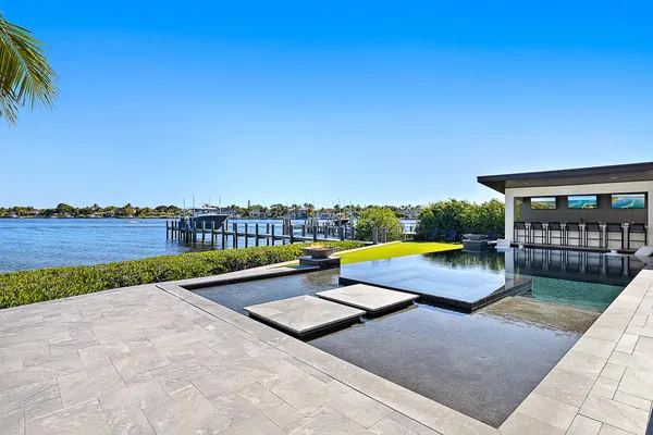 a view of a swimming pool and an outdoor seating