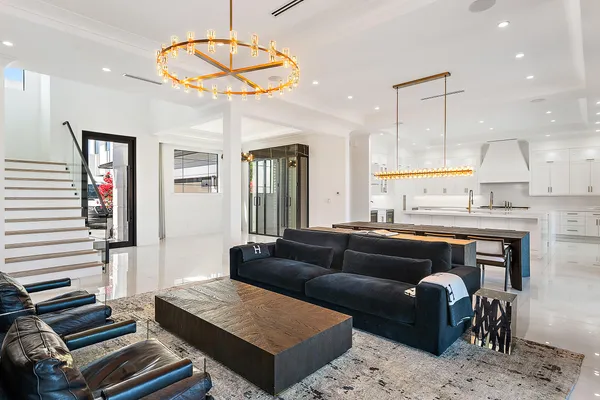 a living room with furniture and a dining table