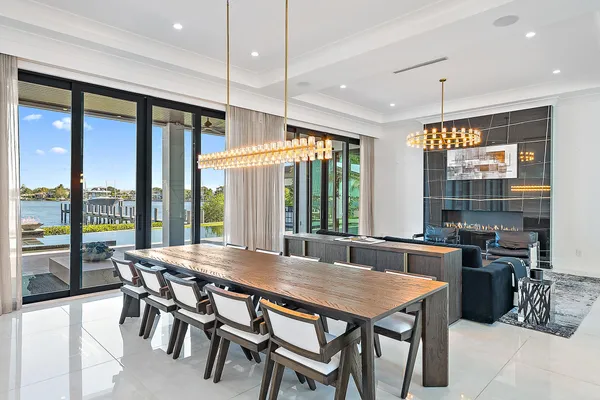 a dining room with furniture a chandelier and wooden floor
