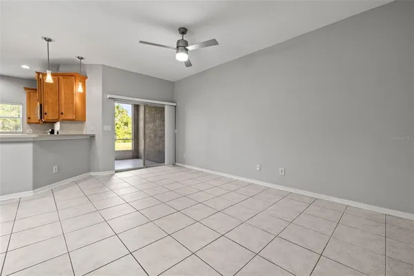 a view of an empty room with window and cabinet