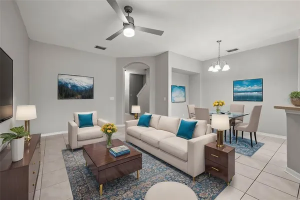 a living room with furniture a rug and a chandelier