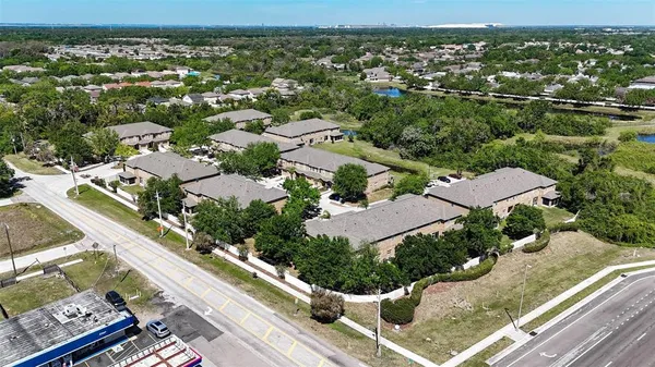 an aerial view of residential houses with outdoor space