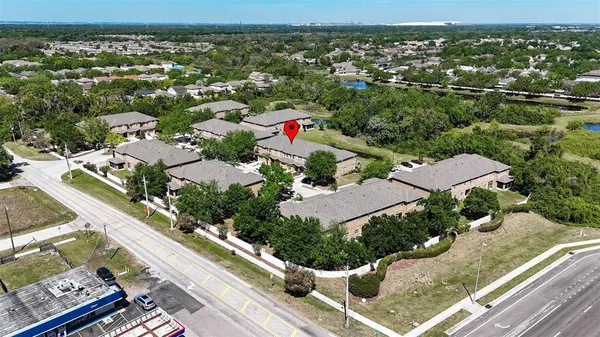 an aerial view of residential houses with outdoor space
