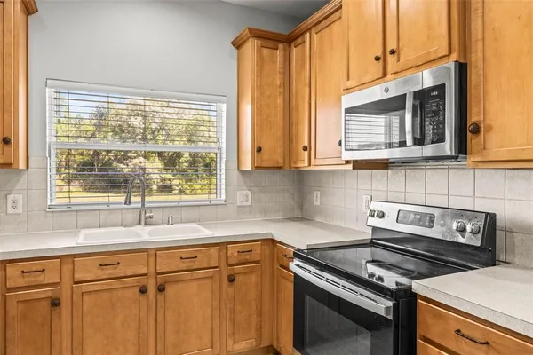 a kitchen with stainless steel appliances a stove sink and cabinets