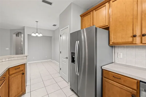 a kitchen with stainless steel appliances granite countertop a refrigerator and a stove