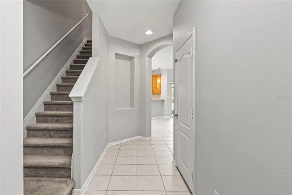 a view of a hallway with wooden floor and entryway
