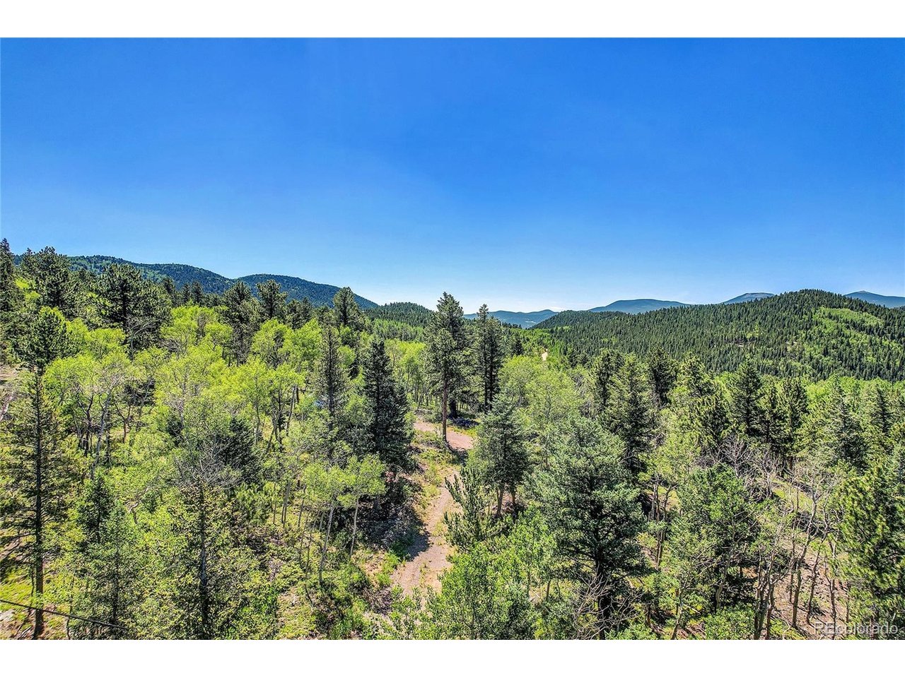 9 Hughesville Road Black Hawk, CO 80422 - Photo 13 of 17 a view of a city with lush green forest