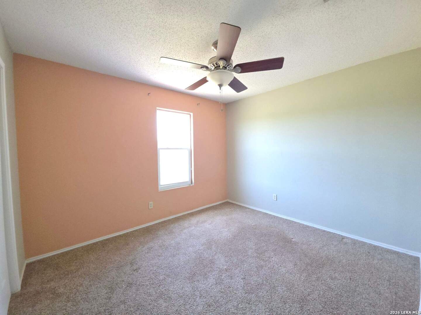 15506 Wheeler Road, Unit 4 Atascosa, TX 78002 - Photo 11 of 23 an empty room with a window and a fan