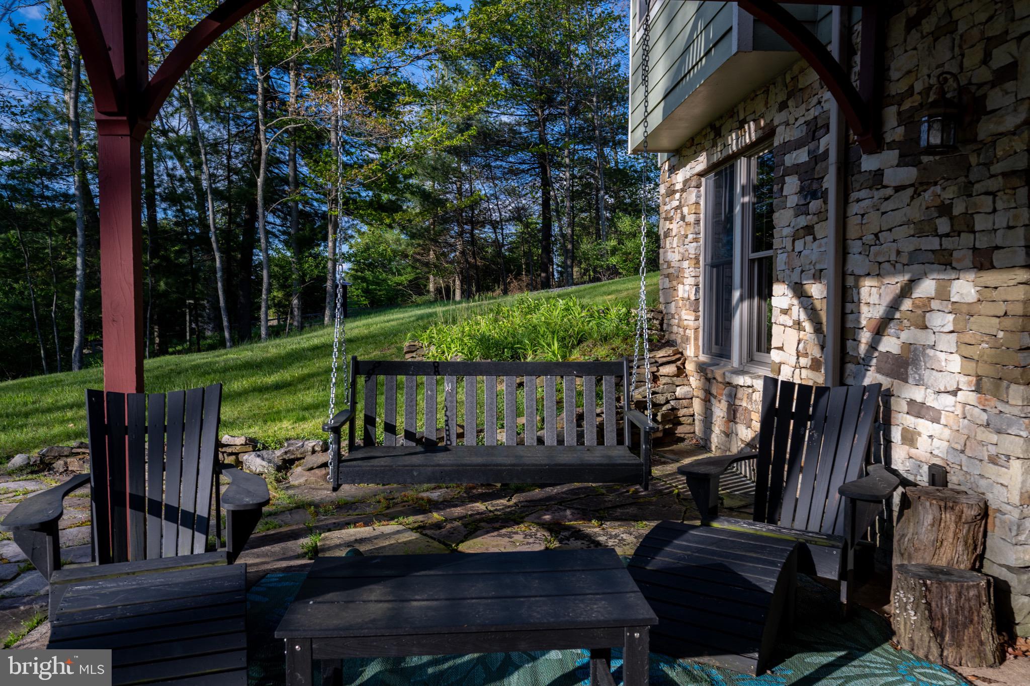 185 Ruta Lane Swanton, MD 21561 - Photo 74 of 81 a view of a patio with table and chairs potted plants and large tree