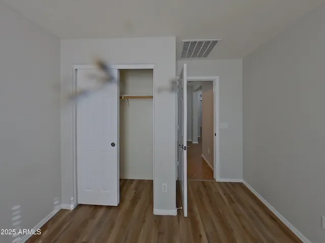 a view of a room with wooden floor and a window