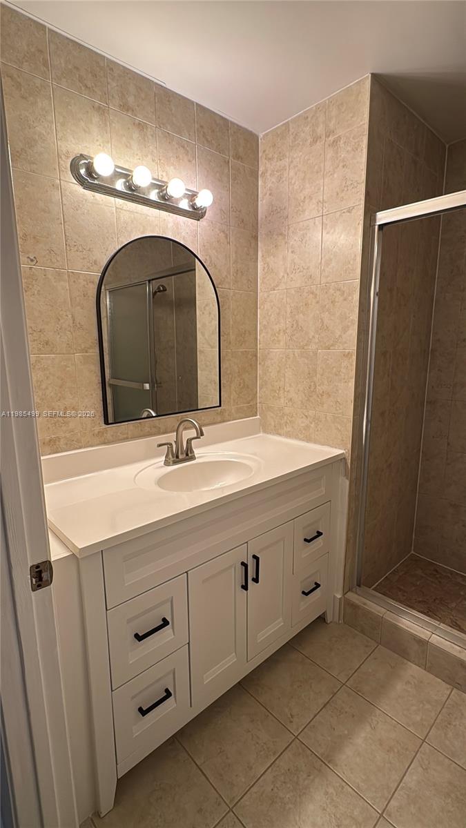 15320 Southwest 106th Terrace, Unit 1118 Miami, FL 33196 - Photo 13 of 25 a bathroom with a double vanity sink and a mirror