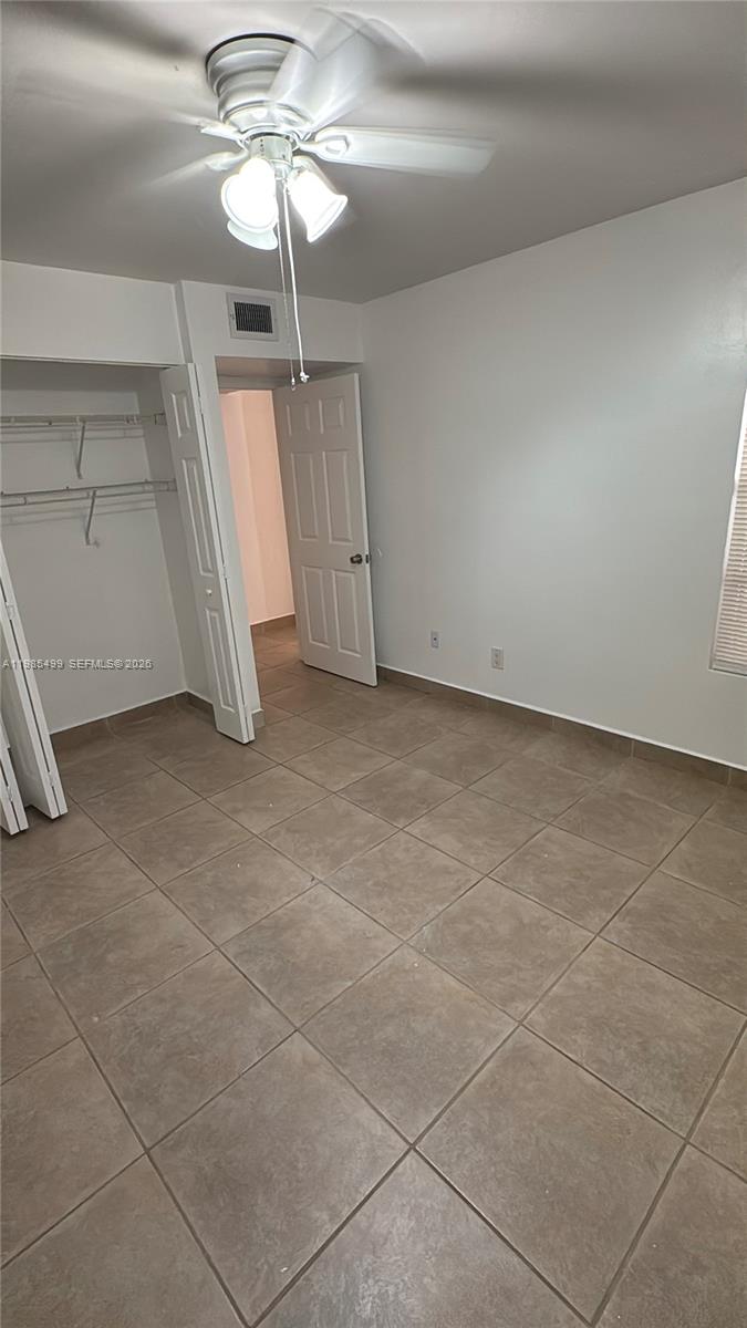 15320 Southwest 106th Terrace, Unit 1118 Miami, FL 33196 - Photo 17 of 25 a view of a livingroom with a ceiling fan and window