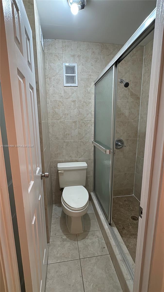 15320 Southwest 106th Terrace, Unit 1118 Miami, FL 33196 - Photo 19 of 25 a bathroom with a toilet and a shower