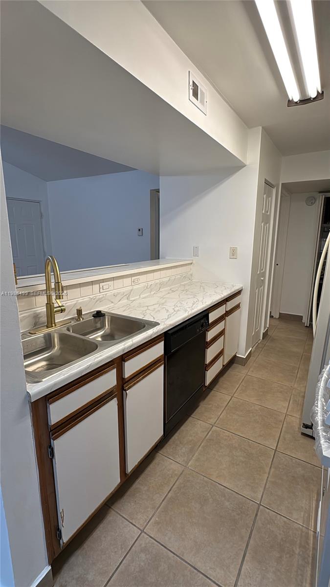 15320 Southwest 106th Terrace, Unit 1118 Miami, FL 33196 - Photo 2 of 25 a kitchen with a sink stove and cabinets