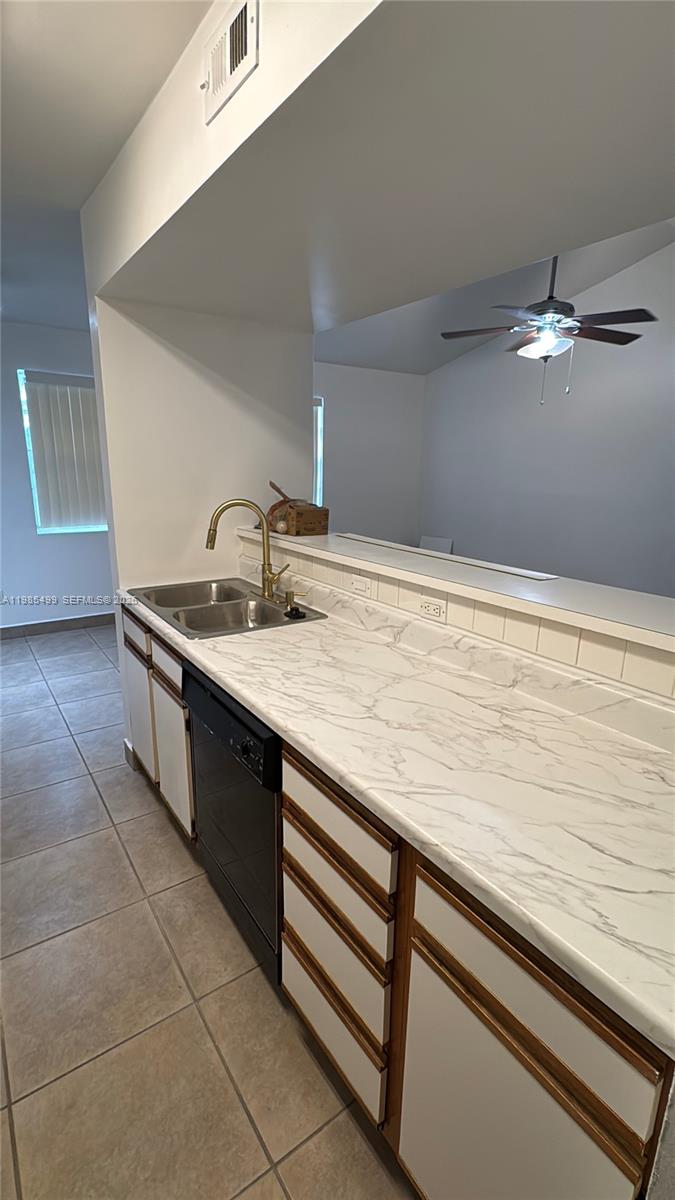 15320 Southwest 106th Terrace, Unit 1118 Miami, FL 33196 - Photo 6 of 25 a kitchen with a sink and cabinets