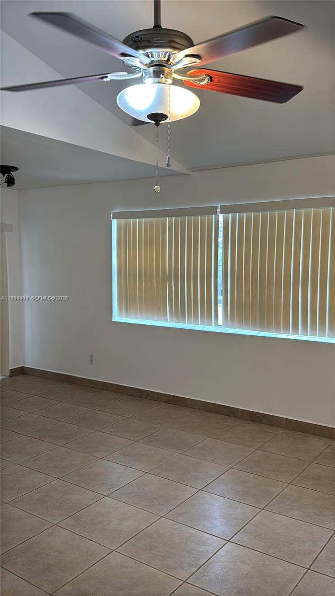 15320 Southwest 106th Terrace, Unit 1118 Miami, FL 33196 - Photo 10 of 25 a view of empty room with a window and chandelier