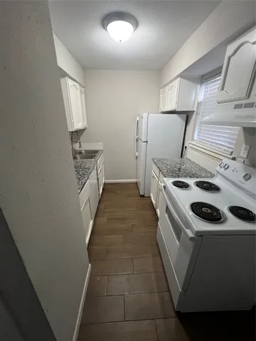 a kitchen with a stove and a sink