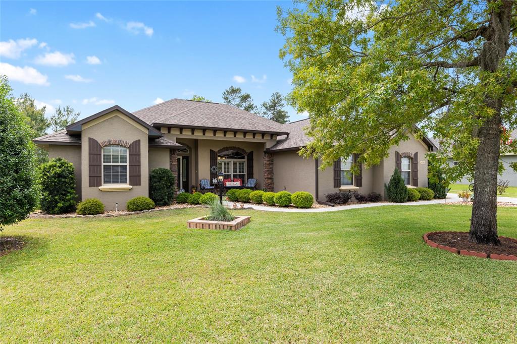 4950 Southwest 114th Street Road Ocala, FL 34476 - Photo 1 of 1 a view of a house with a yard patio and fire pit