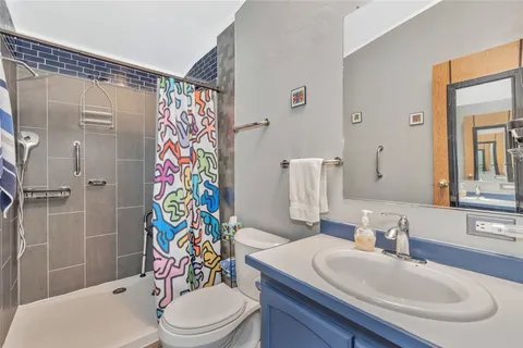 a bathroom with a sink toilet and shower