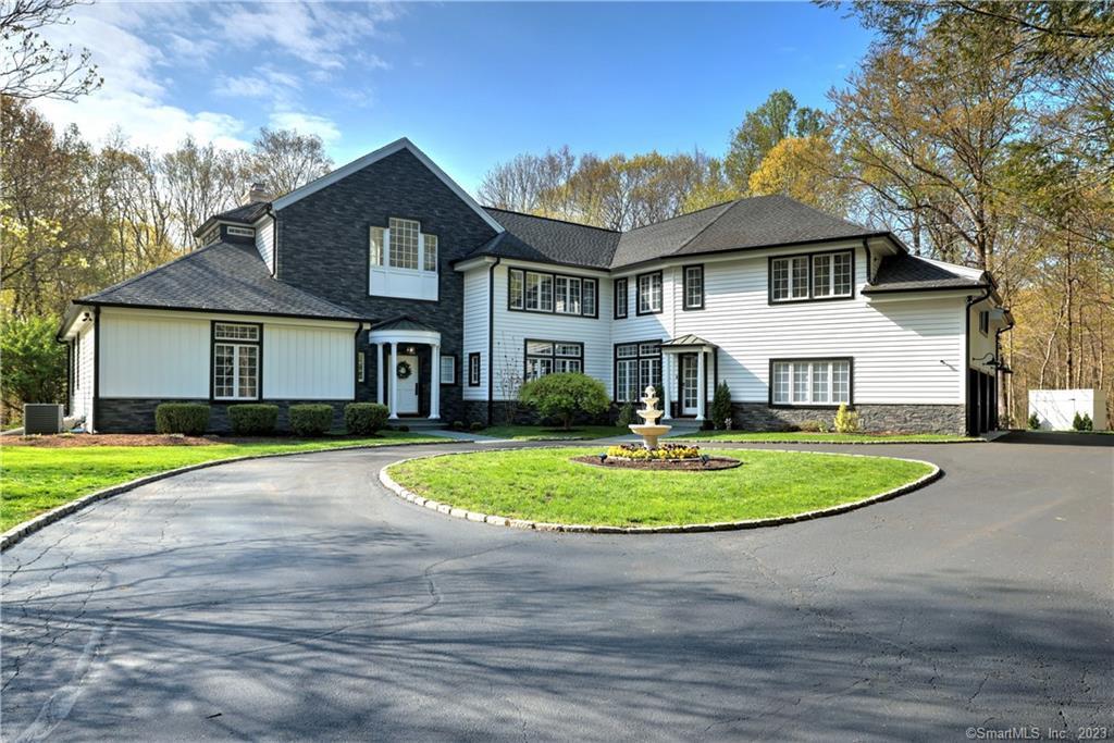 a front view of a house with a yard and porch