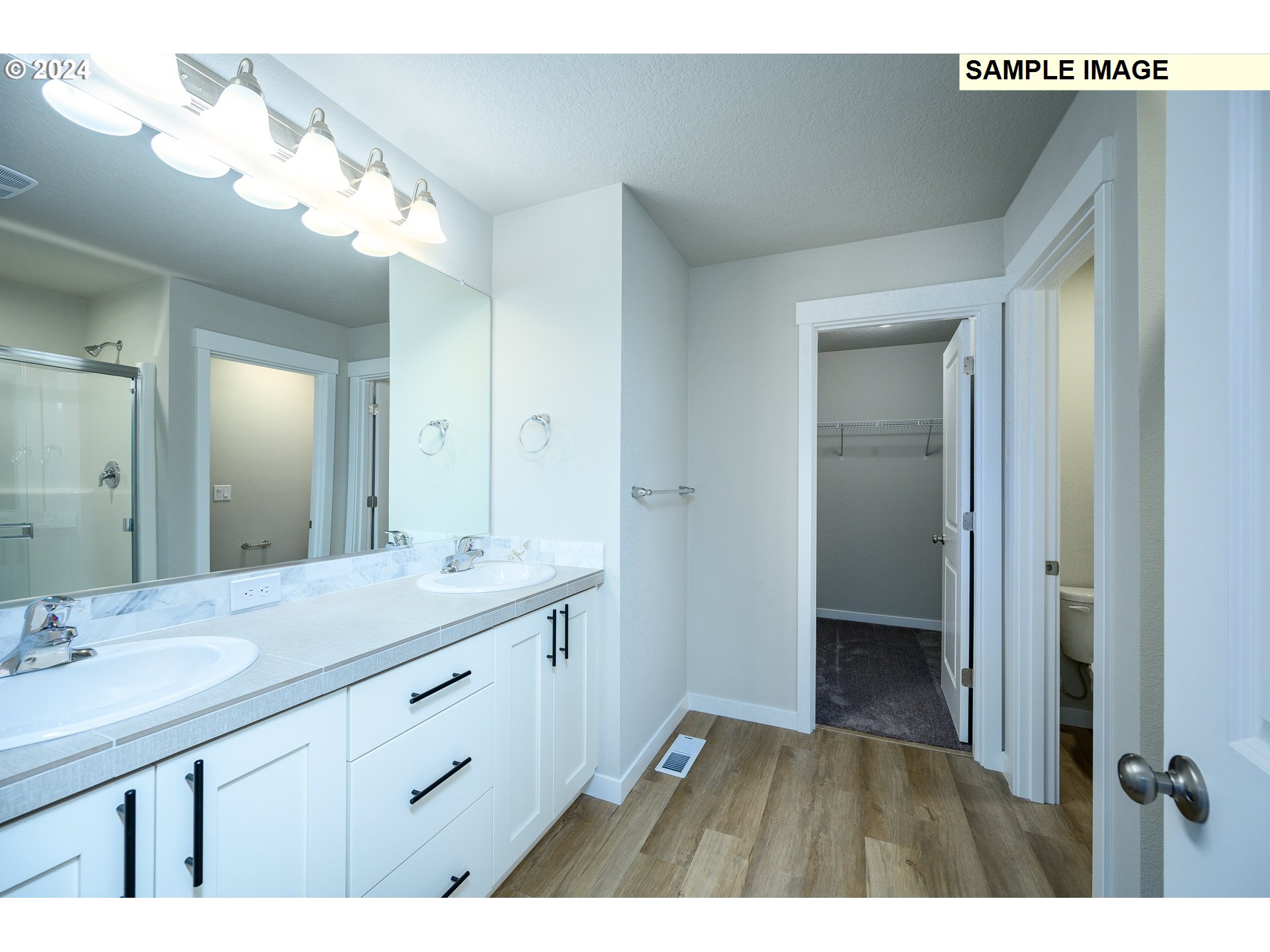 10572 Southeast Heritage Road, Unit 308 Happy Valley, OR 97086 - Photo 13 of 22 a bathroom with a double vanity sink and mirror