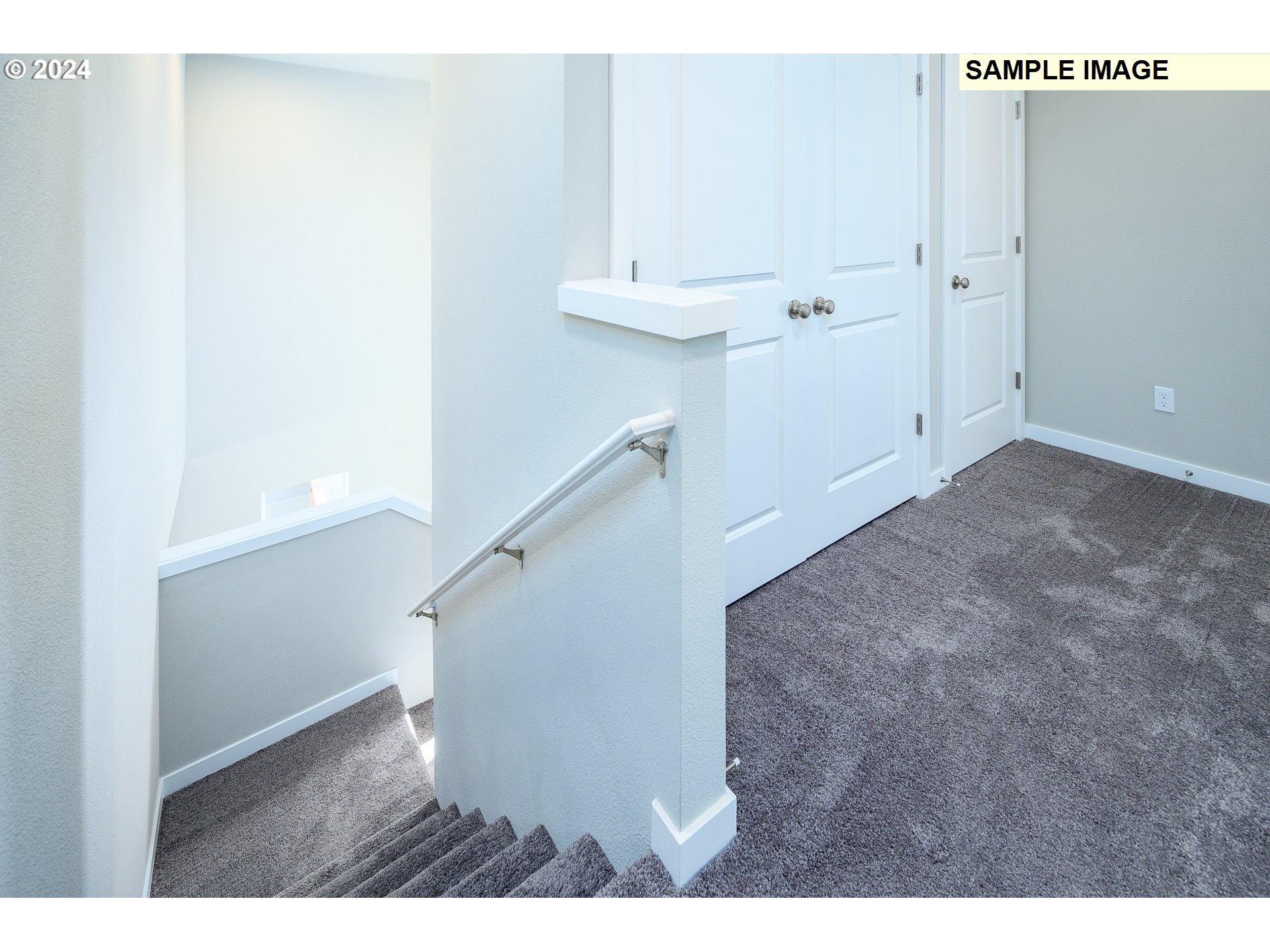 10572 Southeast Heritage Road, Unit 308 Happy Valley, OR 97086 - Photo 16 of 22 a view of a hallway with white walls and a white door