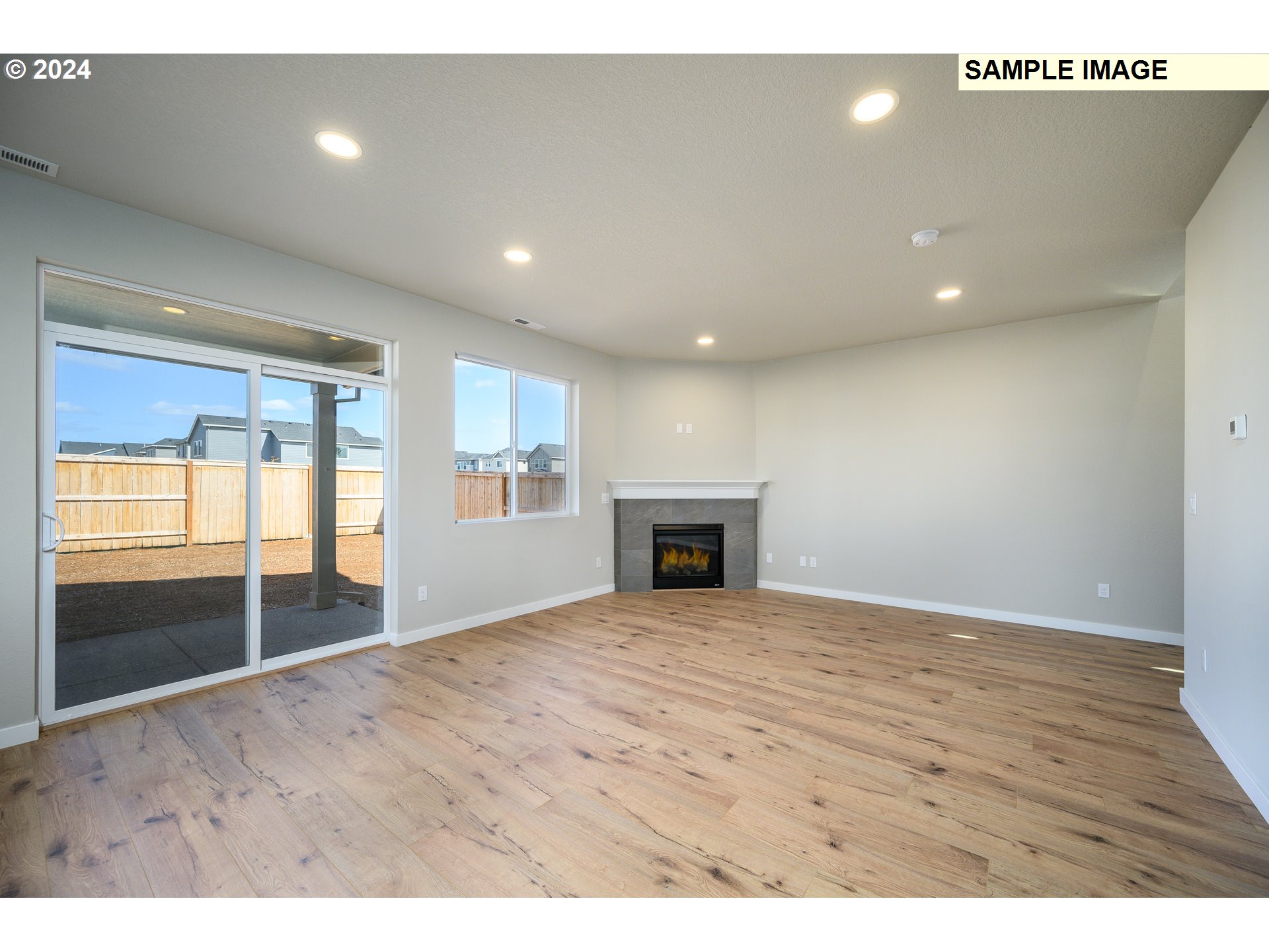 10572 Southeast Heritage Road, Unit 308 Happy Valley, OR 97086 - Photo 22 of 22 a view of empty room with wooden floor and fireplace